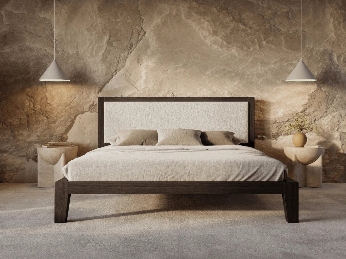 Bedroom with a wooden bed against a stone wall