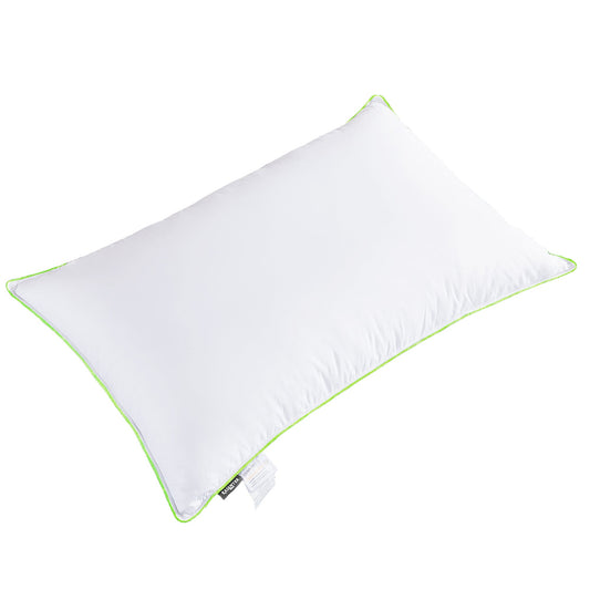 White pillow with green piping on a white background