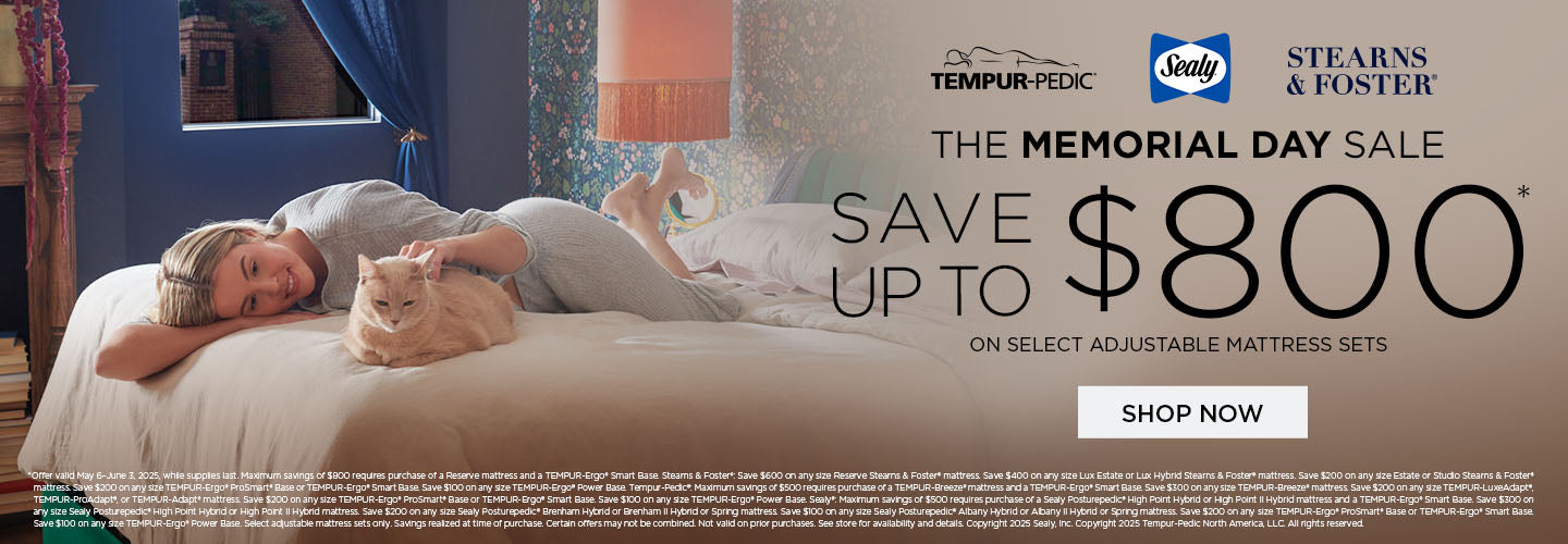 woman laying on bed with cat in ad for memorial day mattress sale
