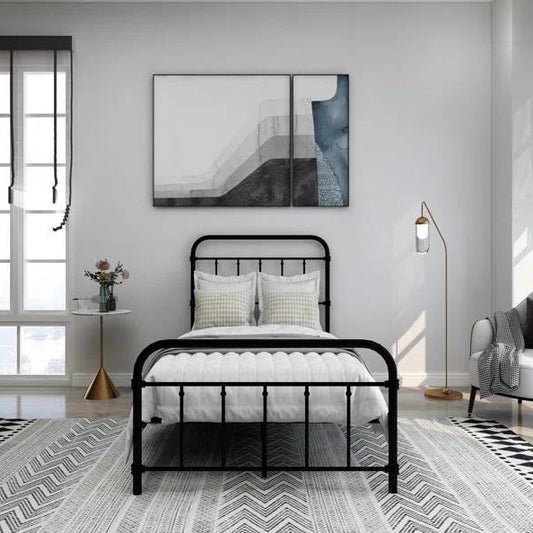 Modern bedroom with a black metal bed, white bedding, and abstract art on the wall.