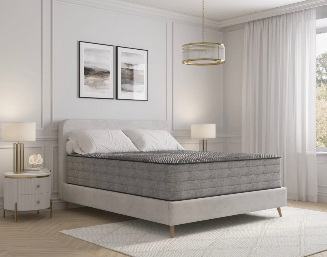 Gray and black mattress on a bed in a modern bedroom with decor elements.