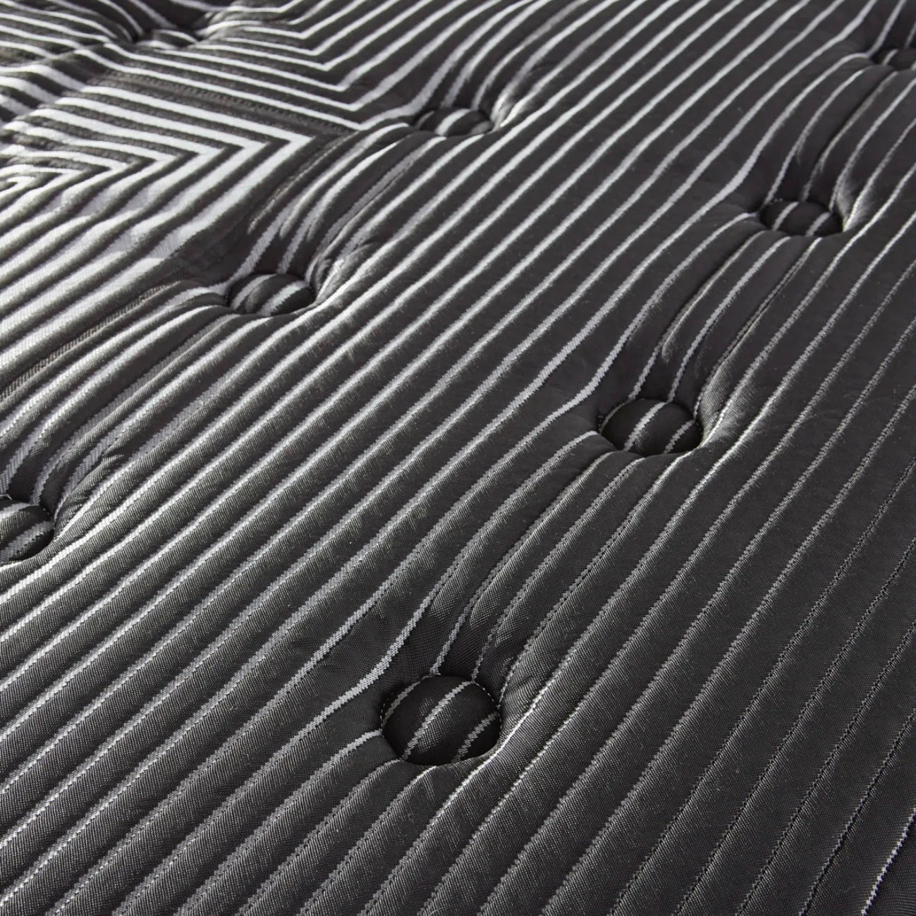 Close-up of a black mattress top with wavy patterns
