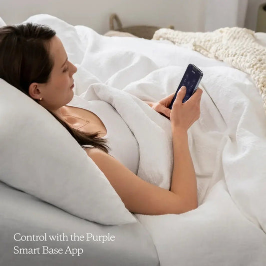 Woman in bed using the Purple premium plus smart base app