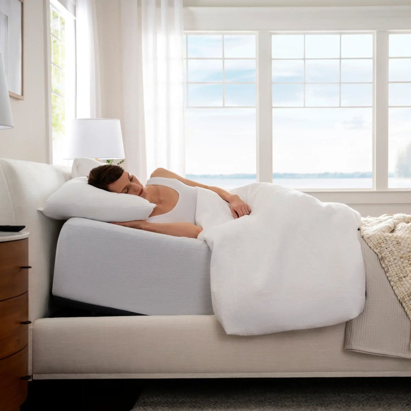 Woman laying comfortably on Purple premium smart base