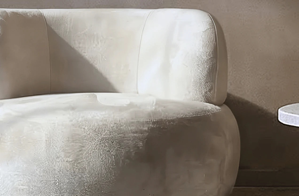 Beige textured armchair against a neutral wall