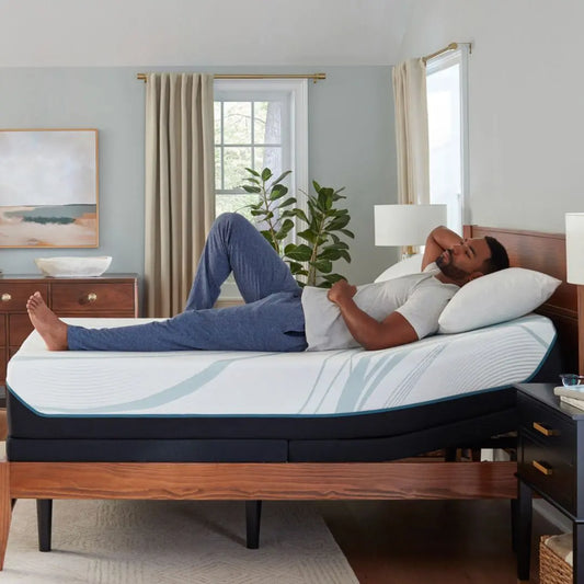 Man lying on a tempurpedic medium adapt mattress on an adjustable power base