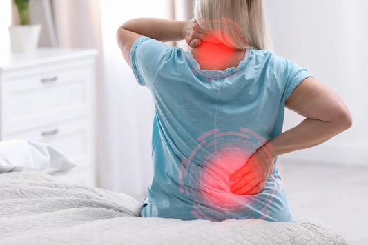 woman having back pain from her old mattress
