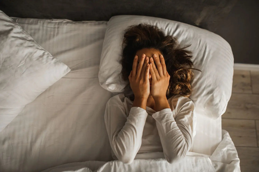 woman in bed unable to sleep