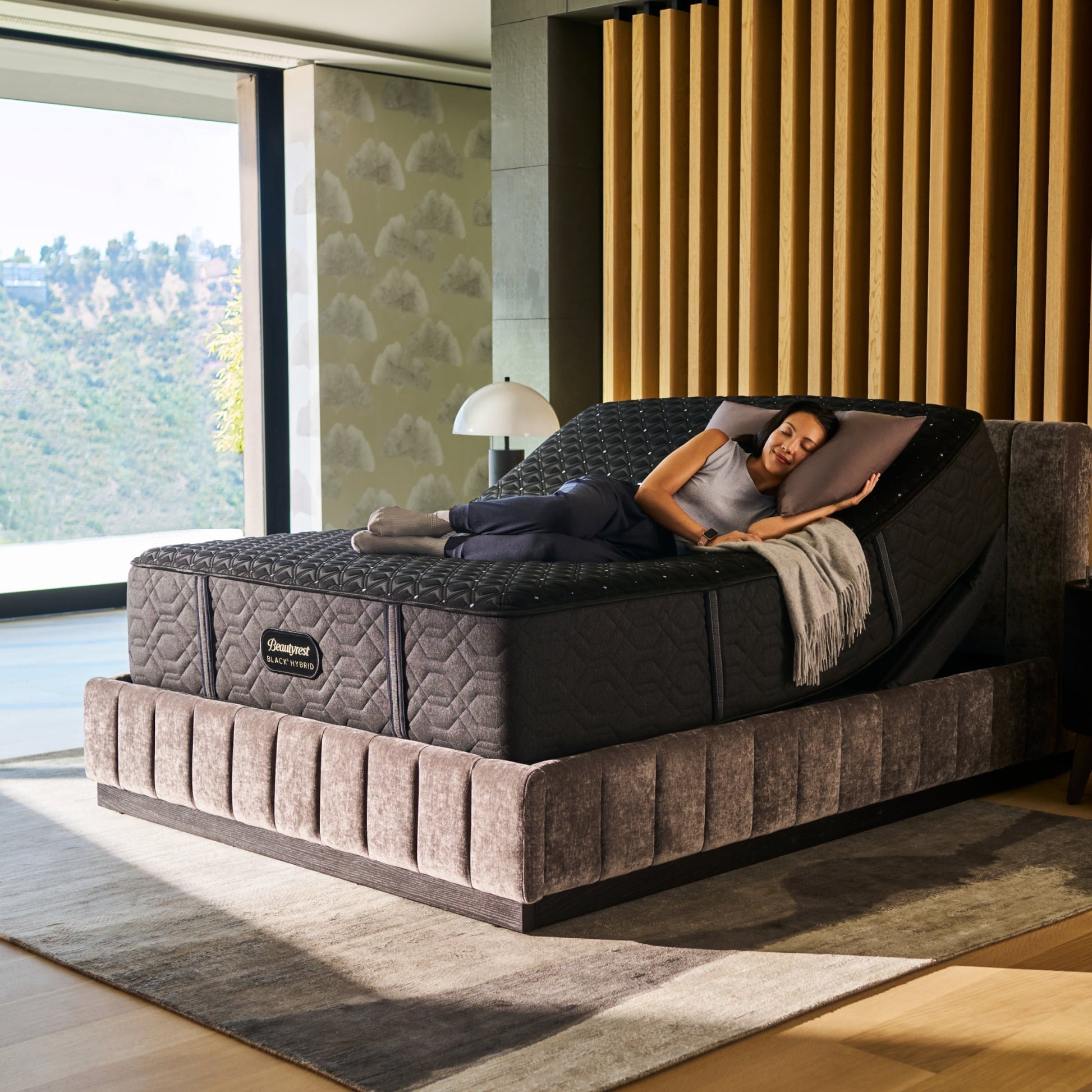 Woman lying on a adjustable bed in a modern bedroom