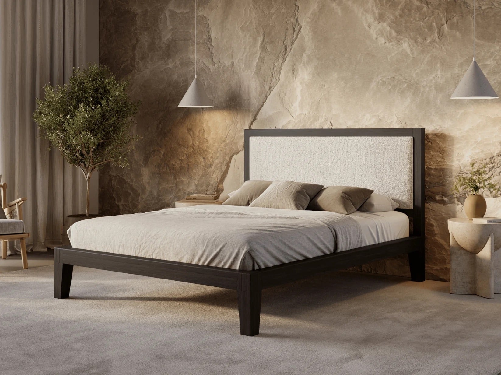 Bedroom with a wooden bed frame, white bedding, and decorative pillows against a textured wall.