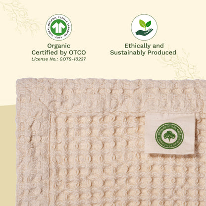 Beige textured fabric with organic certification labels on a beige background