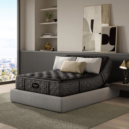 Modern bedroom with a beautyrest black on an adjustable bed frame and decorative elements.