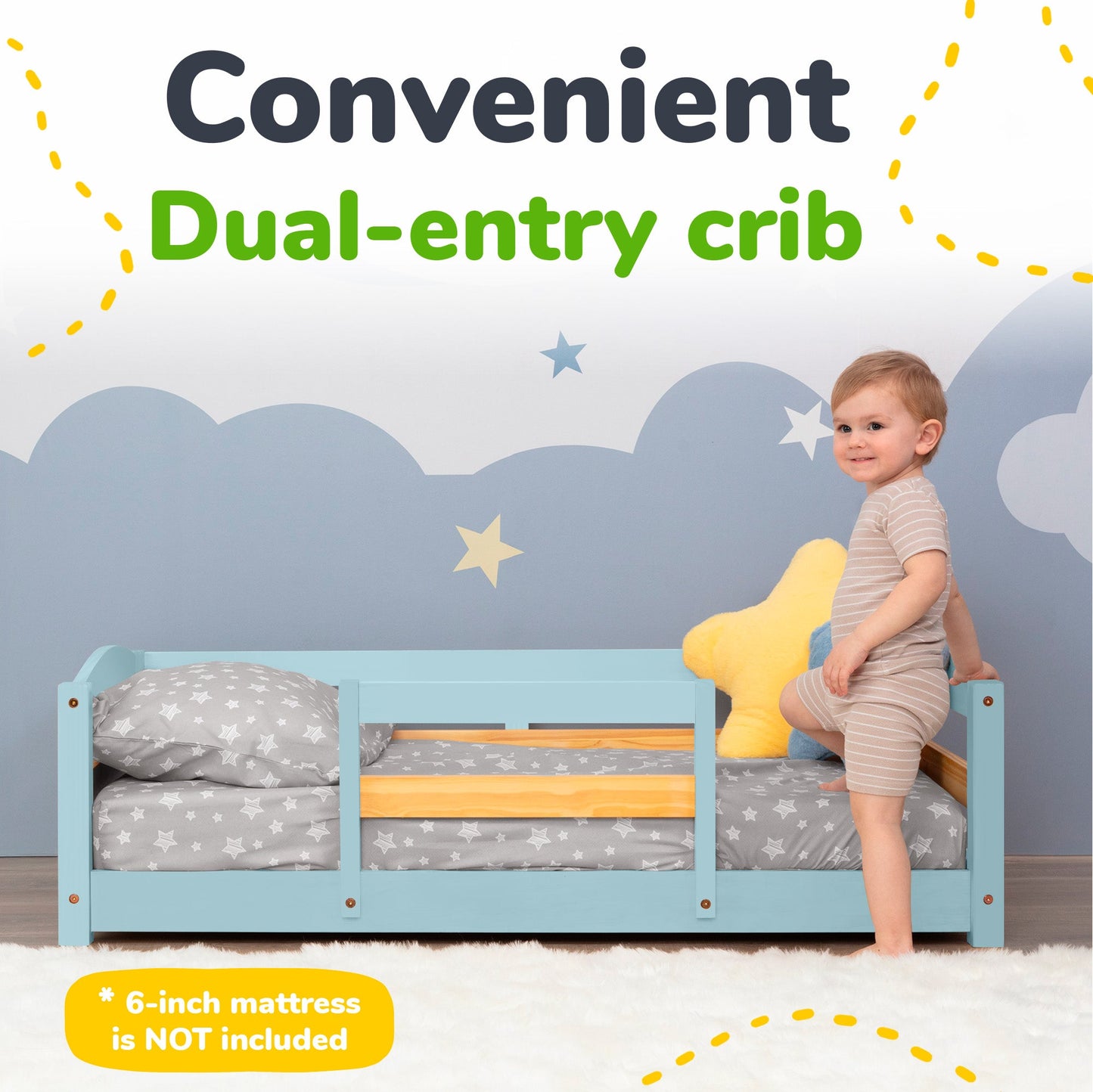Blue dual-entry crib with a child standing on it, against a cloud-patterned wall.
