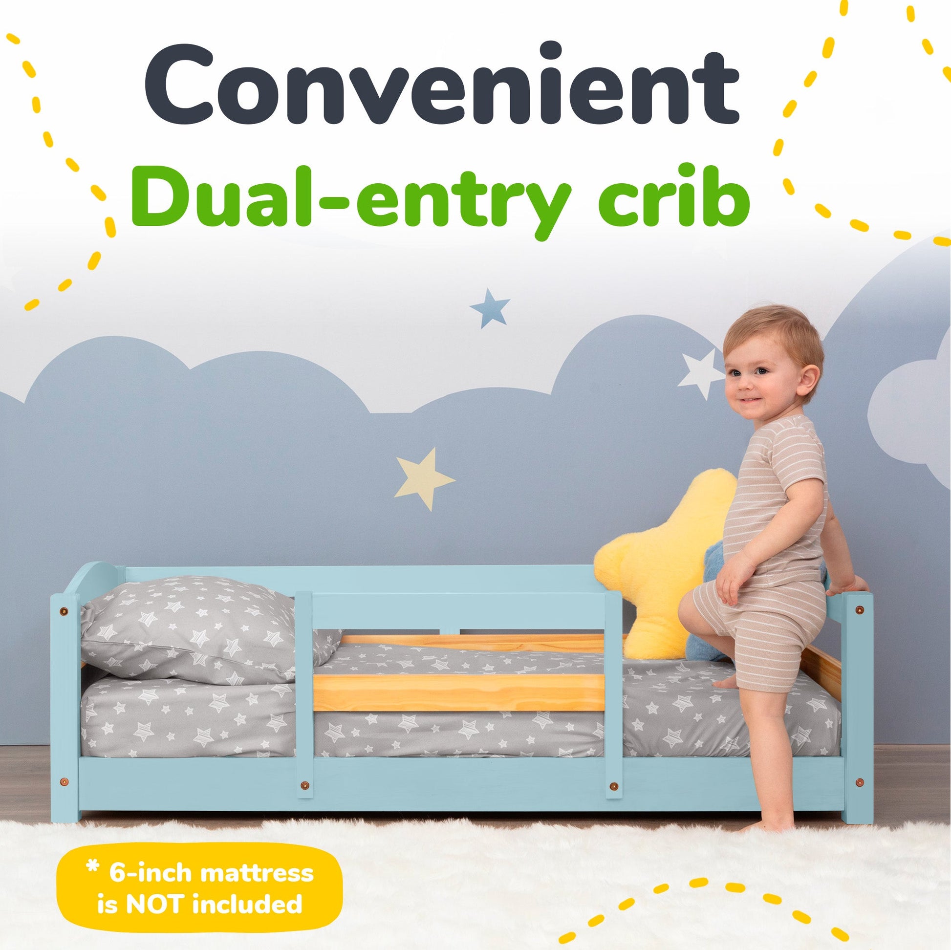Blue dual-entry crib with a child standing on it, against a cloud-patterned wall.