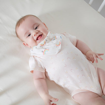 Baby laying on organic cotton crib sheet