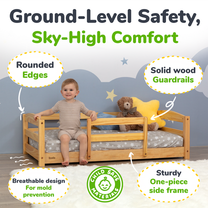 Child sitting on a wooden bed with safety features highlighted, including rounded edges and solid wood guardrails.