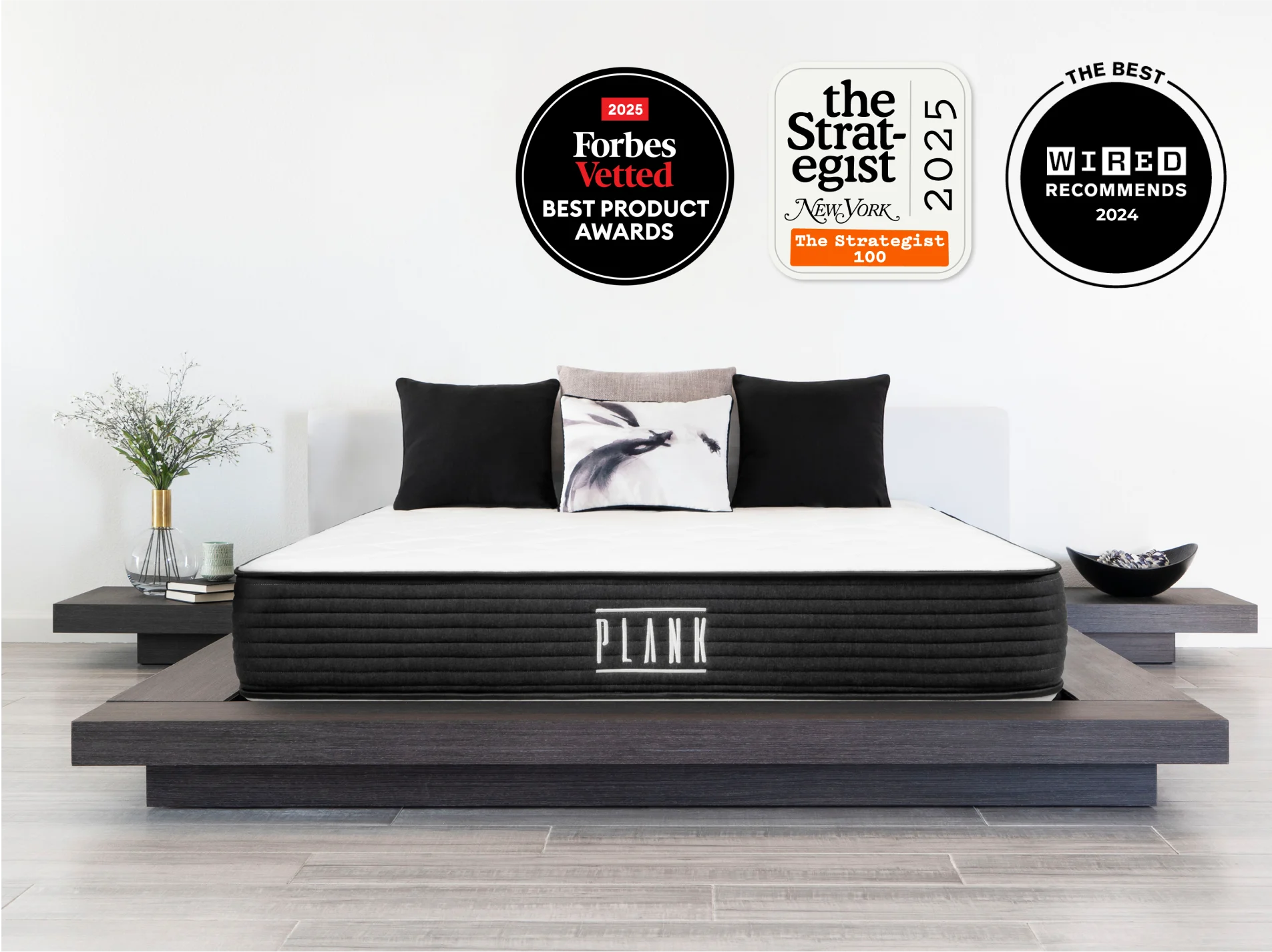 Mattress on a platform bed with award badges above it