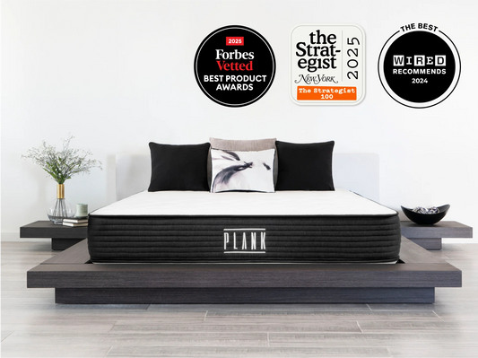 Mattress on a platform bed with award badges above it