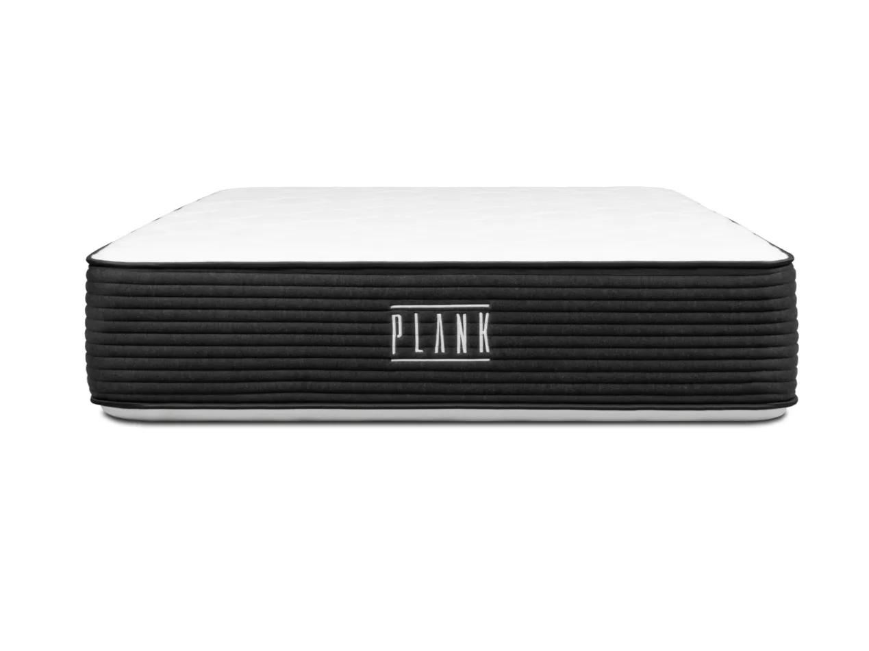 White mattress with black side on a white background, featuring the 'Plank' brand.