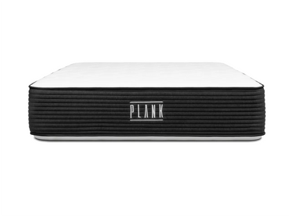 White mattress with black side on a white background, featuring the 'Plank' brand.