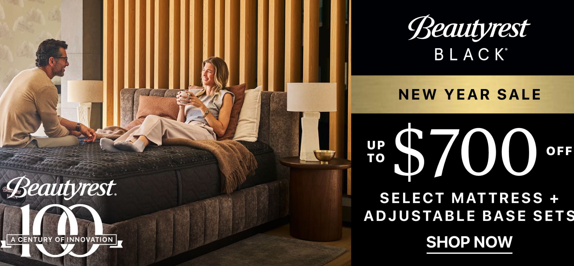 Advertisement for Beautyrest Black mattress and adjustable base sets with a couple on a bed.