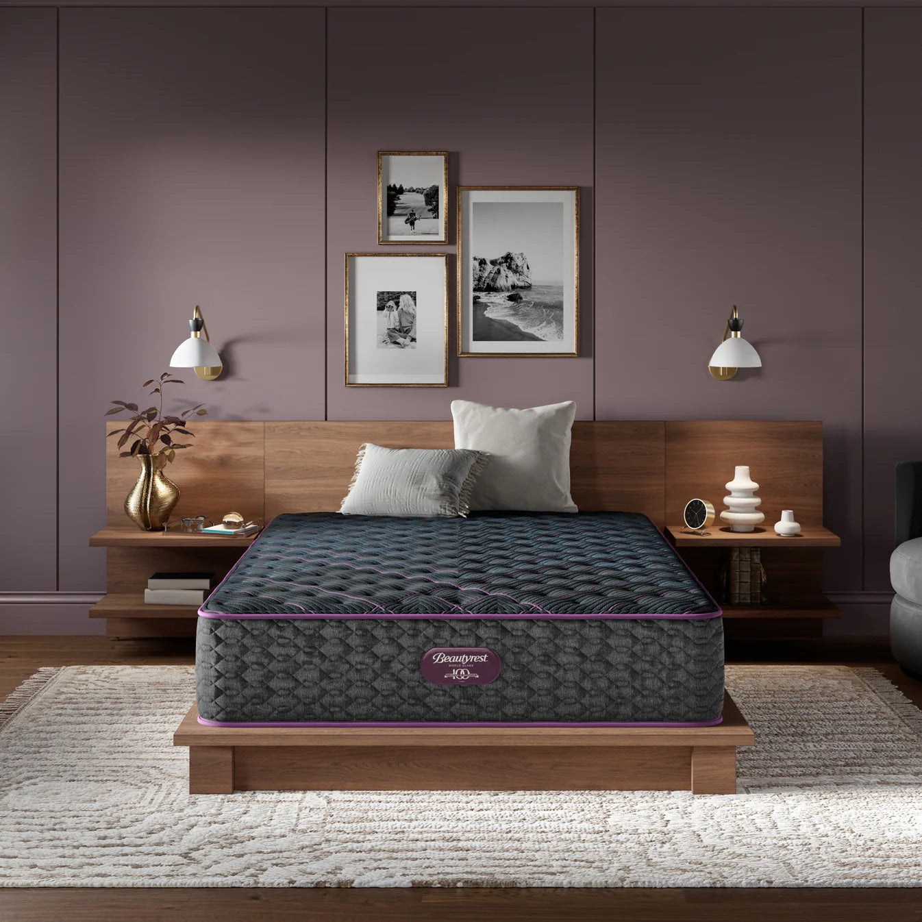 Mattress on a wooden bed frame in a bedroom setting with purple walls and decor.