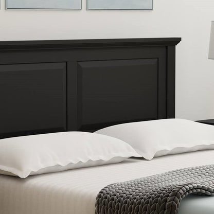 Black king size wooden headboard with white pillows and a gray blanket on a bed.