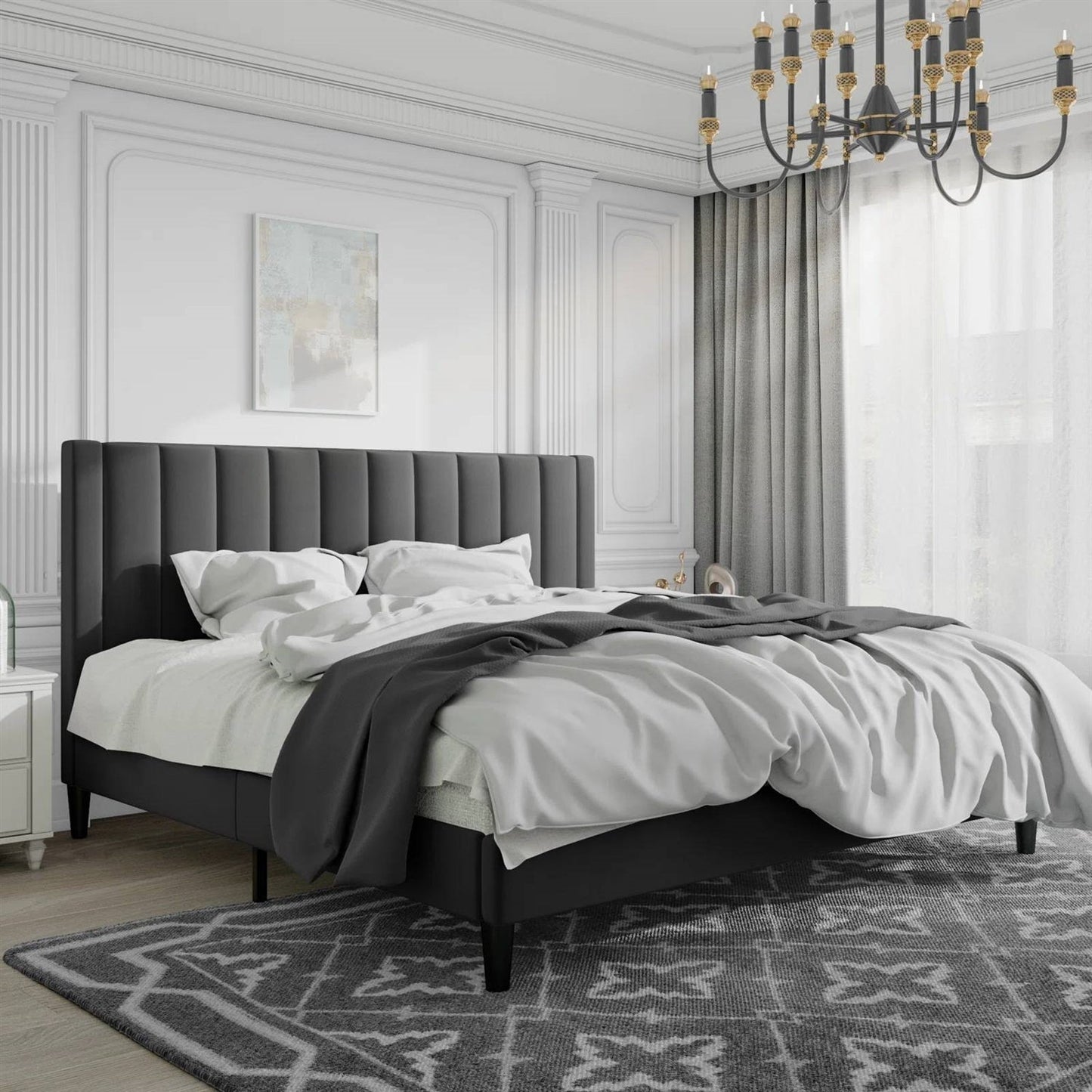 Modern bedroom with a black king size velvet upholstered bed, white bedding, and decorative rug.