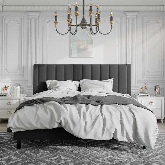 King size velvet upholstered bed in a bedroom with white walls and decorative elements.