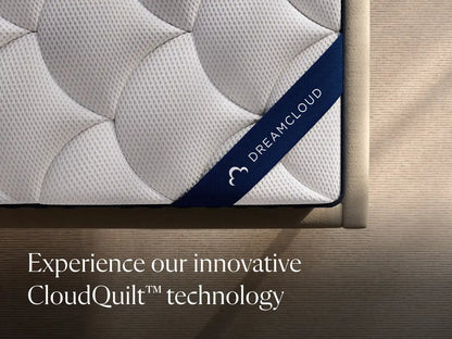DreamCloud mattress with branding and text on a wooden bed frame.