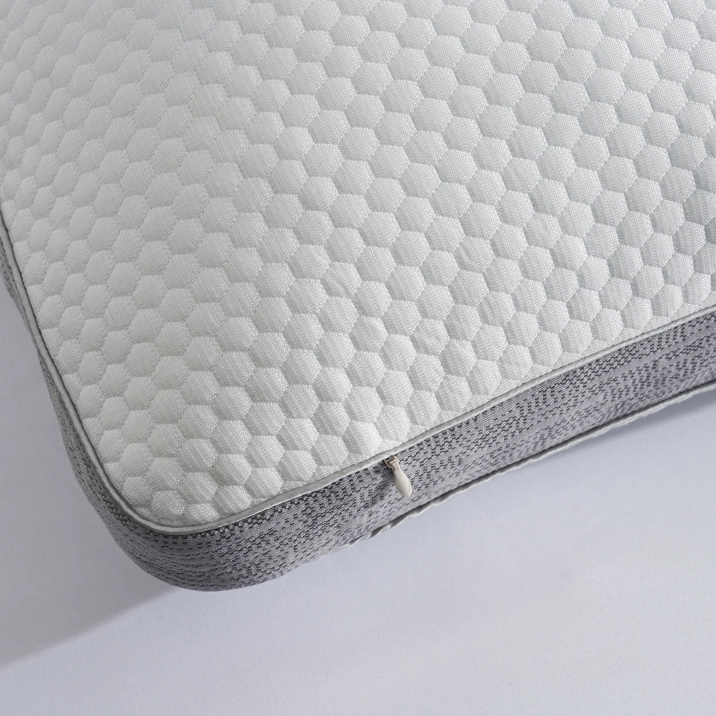 Close-up of a quilted cooling pillow cover on a white background
