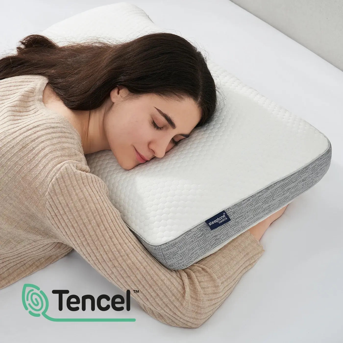 Woman sleeping on a pillow with Tencel logo in the corner