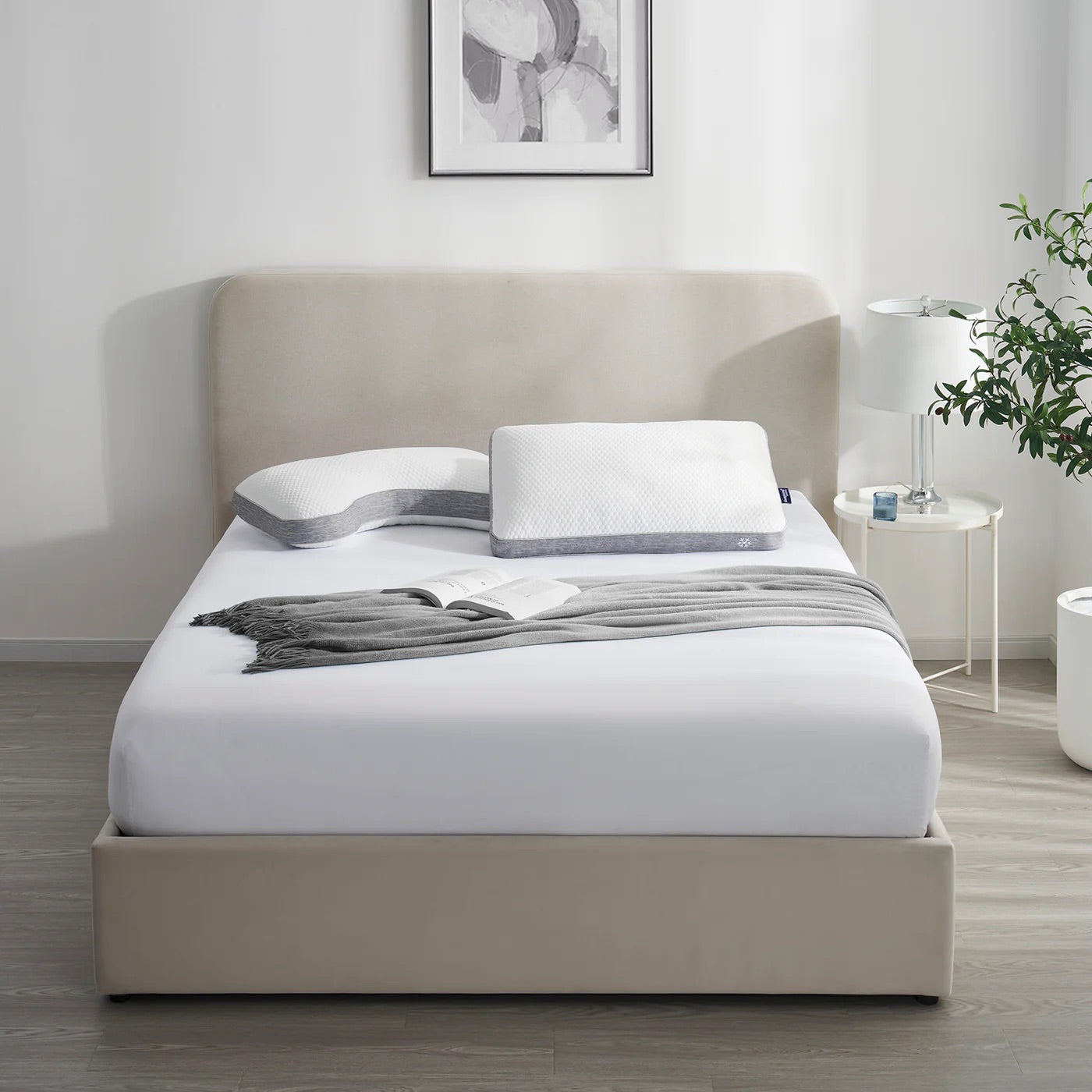 Beige bed with white bedding in a modern bedroom setting