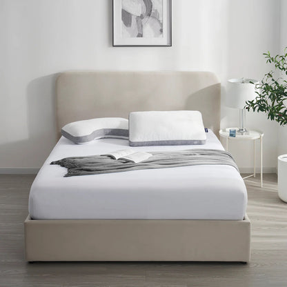Beige bed with white bedding in a modern bedroom setting