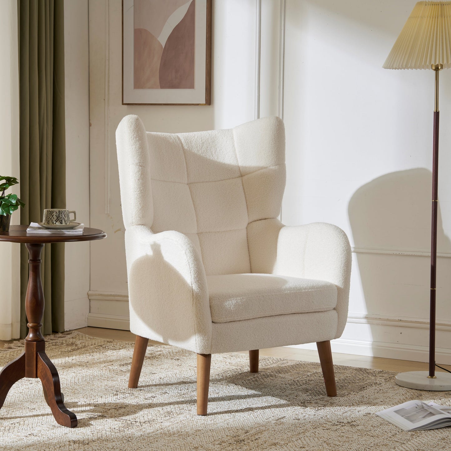 Beige armchair in a living room setting with a side table and lamp.
