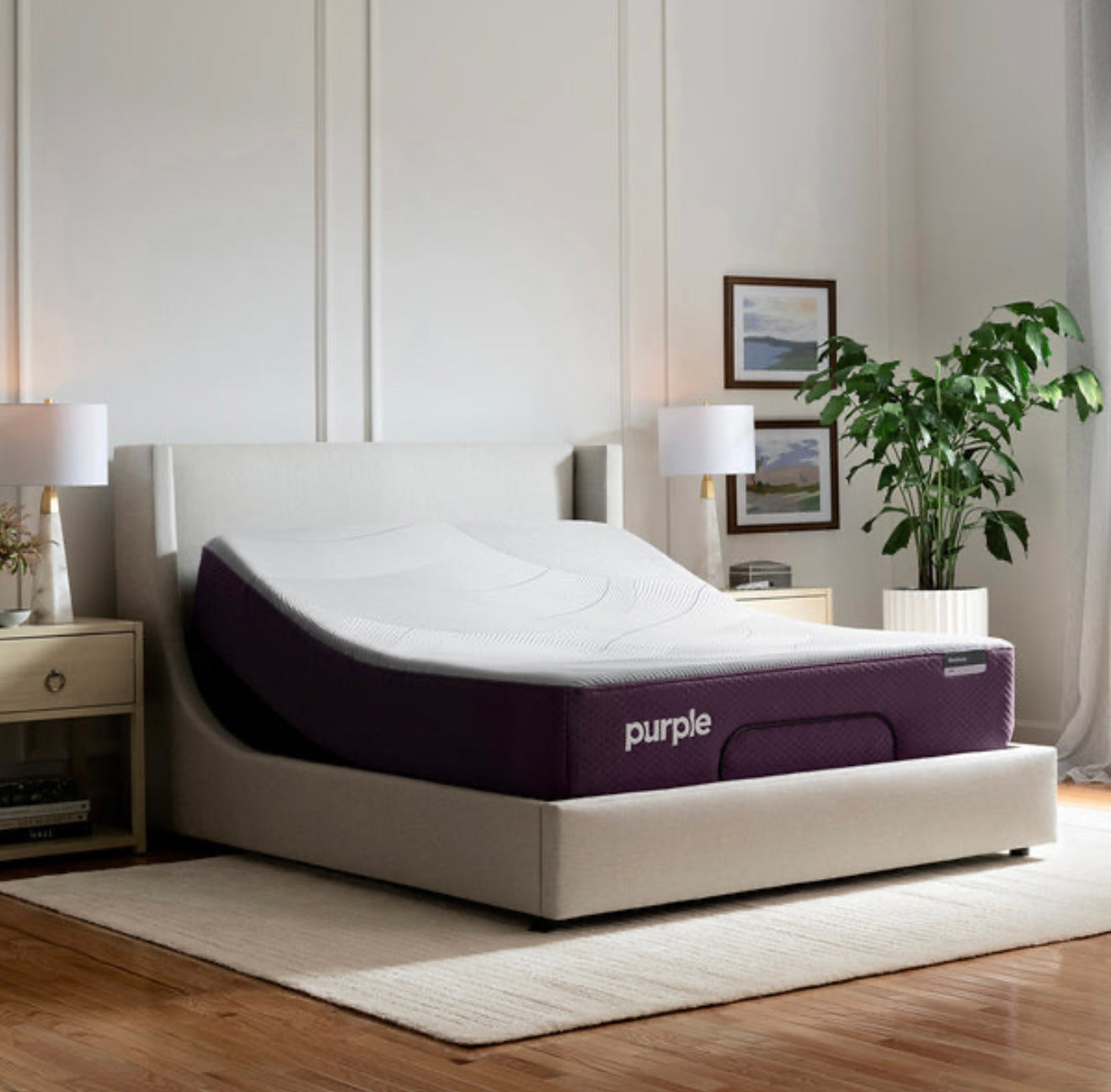 Purple adjustable bed in a modern bedroom setting with decor elements.