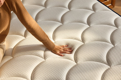 Person touching a textured mattress surface