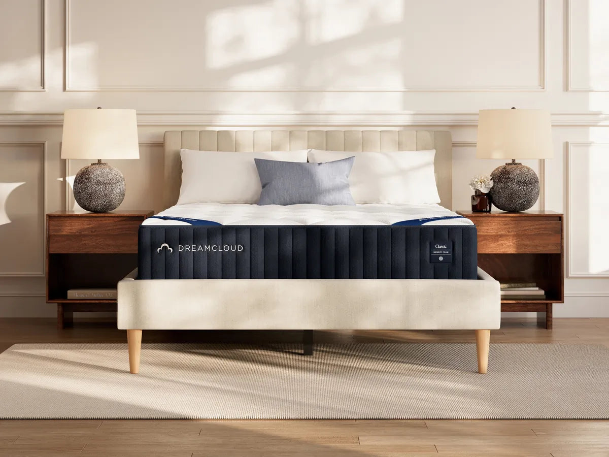 DreamCloud mattress on a bed in a bedroom setting with lamps and decor.