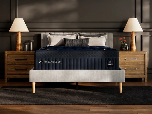 DreamCloud mattress in a bedroom setting with nightstands and lamps.