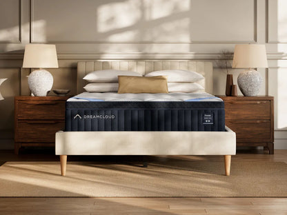 DreamCloud mattress in a bedroom setting with wooden nightstands and lamps.
