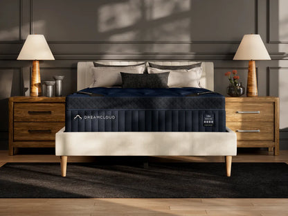 DreamCloud mattress in a bedroom setting with wooden nightstands and lamps.