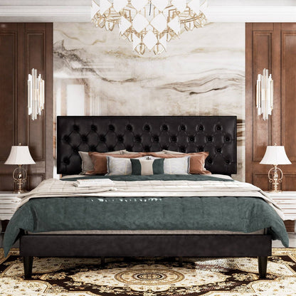 Luxurious bedroom with a black faux leather tufted bed frame, marble wall, and elegant chandelier.