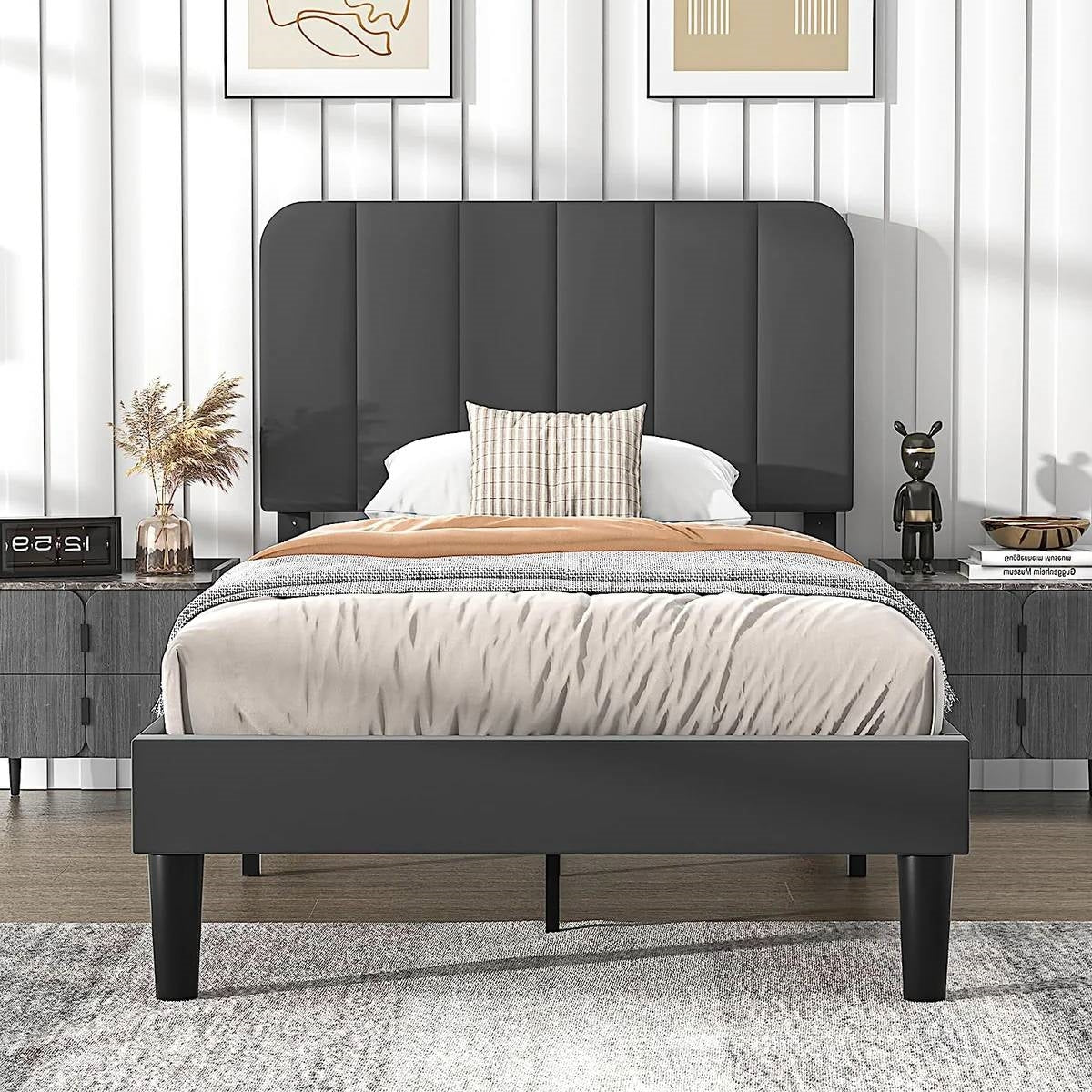 Twin gray upholstered platform bed frame in a bedroom setting with decor elements.