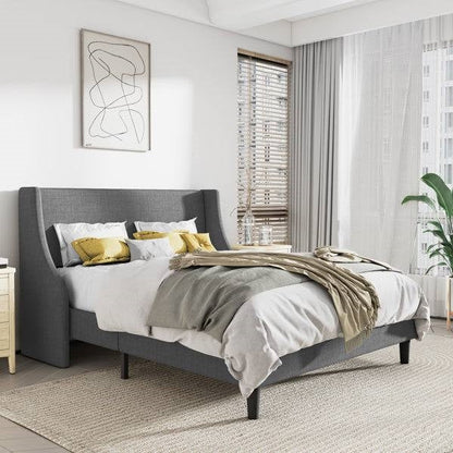 King size gray linen upholstered bed in a modern bedroom with abstract art and curtains.