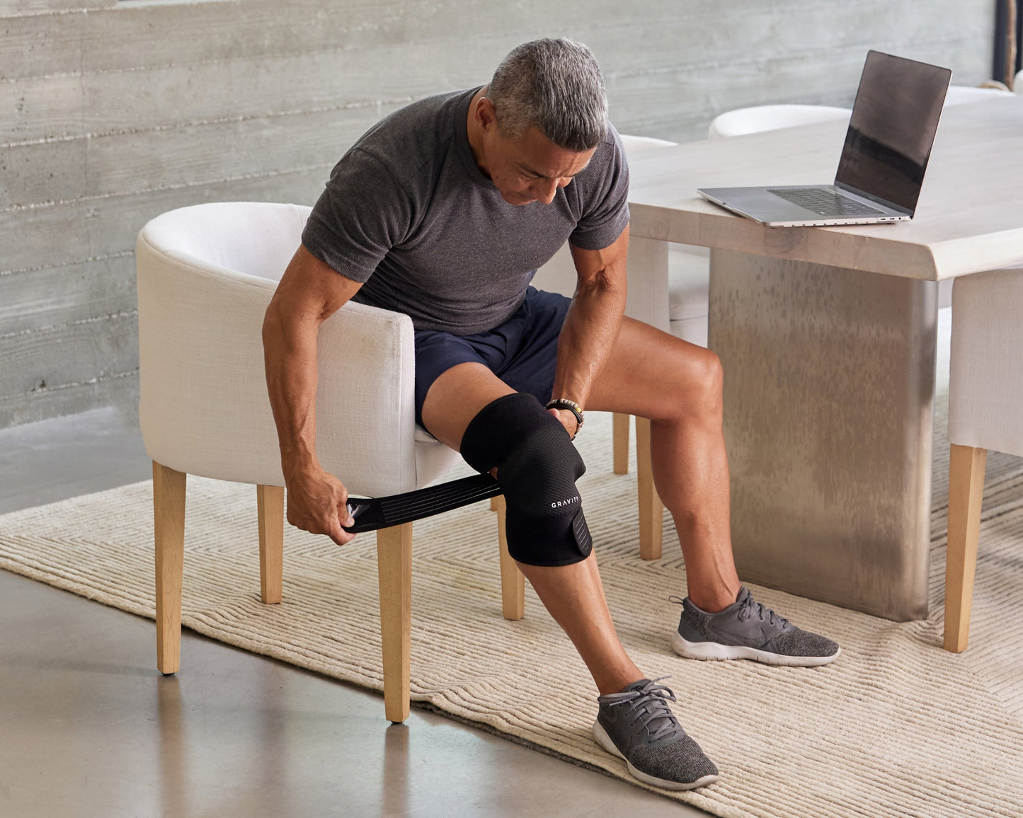 Man applying an infrared knee wrap