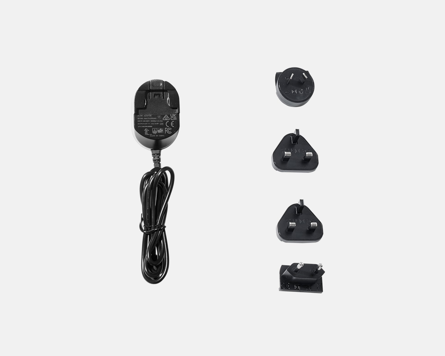 Set of black electrical adapters and plug on a white background
