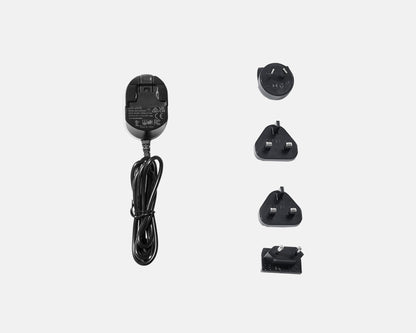 Set of black electrical adapters and plug on a white background