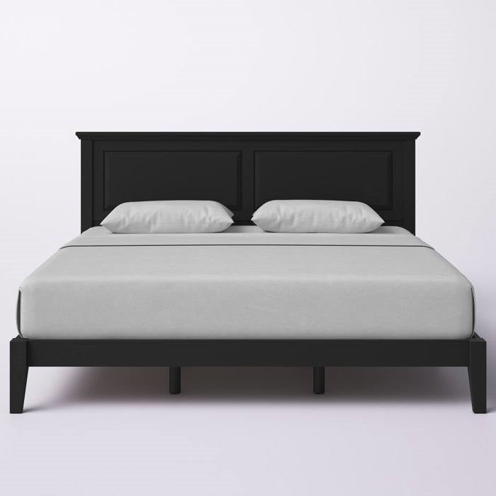 Black king size bed frame with white mattress and pillows on a light gray background