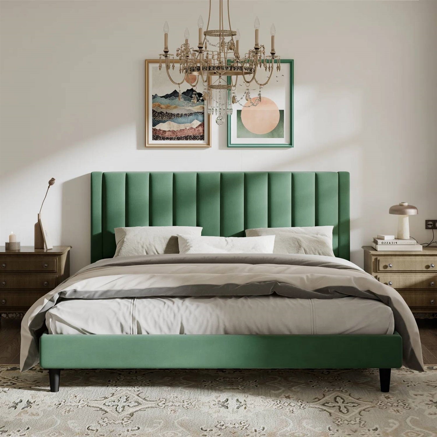 King size green velvet upholstered bed in a bedroom with a chandelier and framed artwork on the wall.