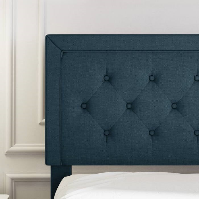 King size Blue tufted headboard against a white wall